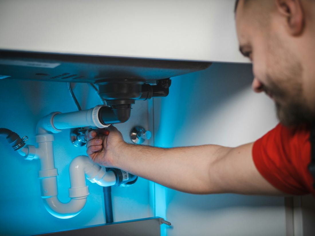 A plumber at work on a job